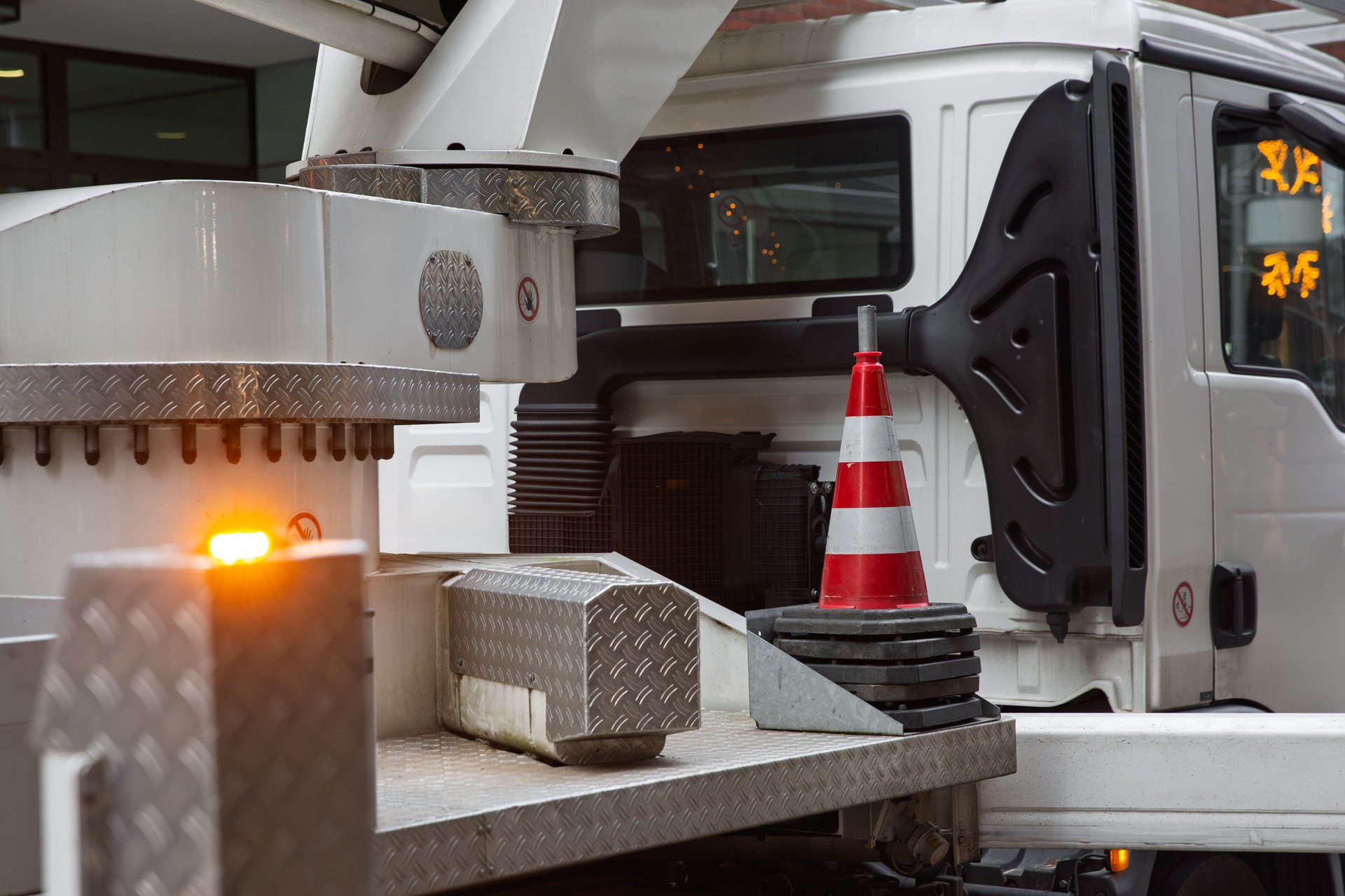 Traffic cone placed on a truck platform with flashing lights